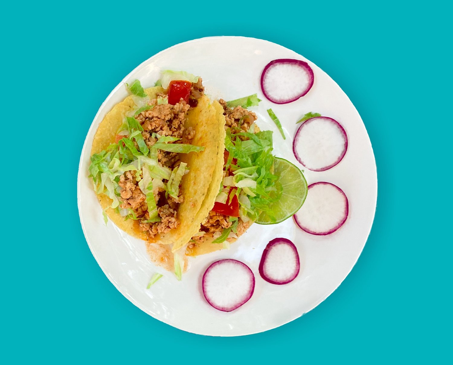 A white plate with Taco in it on blue background