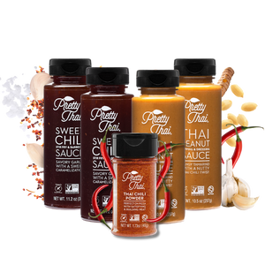 A pack of 5 Pretty Thai products. The products include two  Sweet Chili Stir Fry and Barbecue Sauce bottles, two Peanut Dipping and Dressing Sauce bottles, and a Thai Chili power bottle. The Background is white and some vegetables can be seen. 