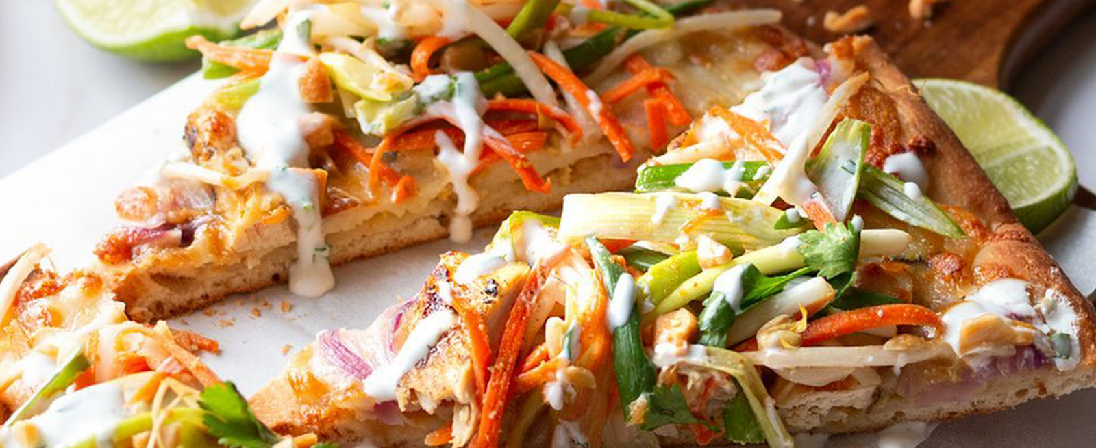 Two slices of pizza on a wooden board.               