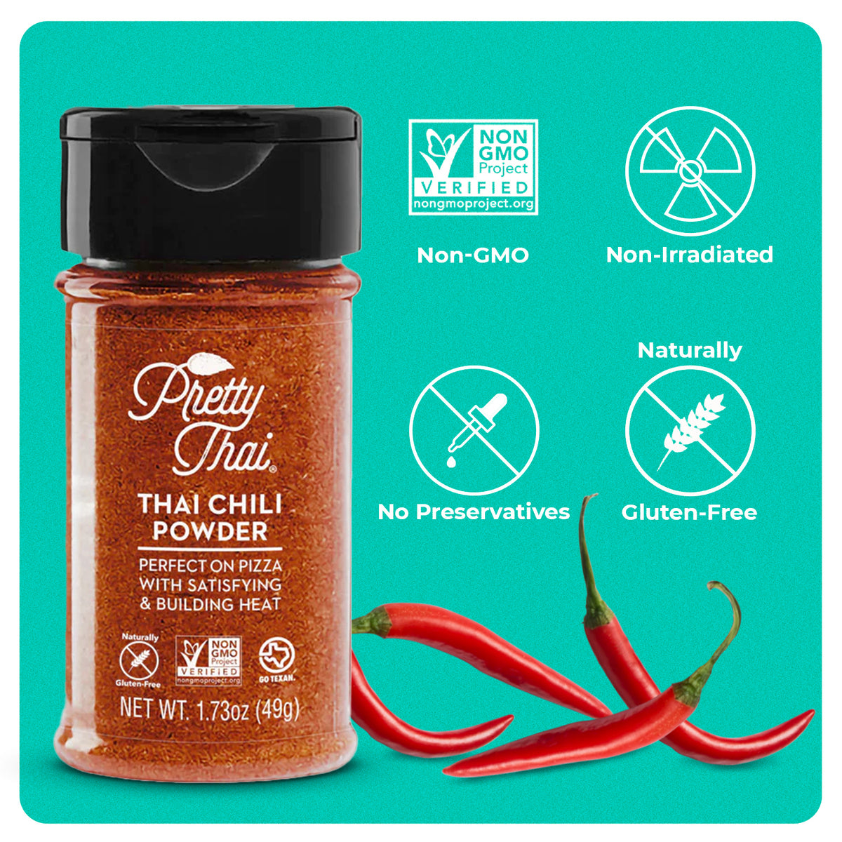 A bottle of Pretty Thai’s Thai Chili Powder. which will be perfect on pizza with satisfying and building heat. Net WT. 1.73 oz (49 g) is also written on it under different labels. In the background, red chilis can be seen.