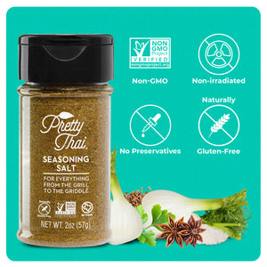A bottle of Pretty Thai Seasoning Salt. In the bottom right corner, different vegetables can be seen. 4 icons can be seen which read “Non-GMO, Non-irradiated, No Preservatives, and Naturally Gluten-Free