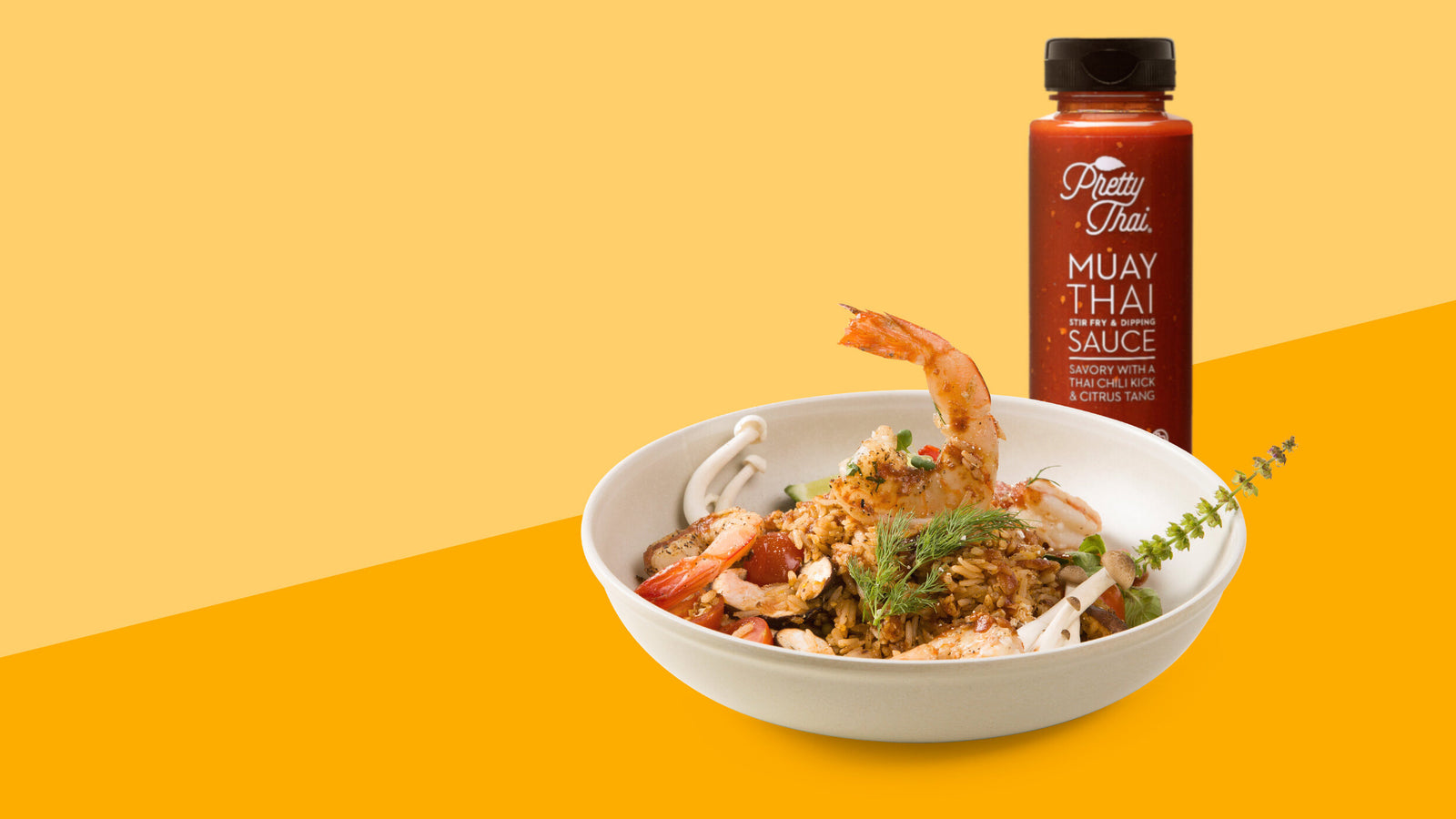 dish made of shrimp placed in a bowl and pretty thai muay sauce bottle placed behind
