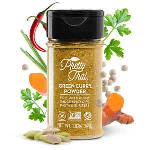 A bottle of Pretty Thai Green Curry Powder. which is for the green curry sauce, spicy dips, pasta and burgers. Net WT.  1.83 oz (52 g)  is also written on it under different labels. In the background, different vegetables and can be seen.