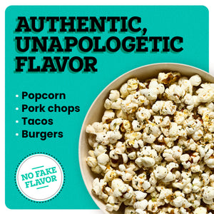 A bowl with popcorn on a yellow background. The border of the background is white. At the top left corner “Authentic, Unapologetic Flavor” is written in bold black font. Under this text, white bullet points read “Popcorn, Pork Chops, Tacos, and Burgers”. A white icon in the bottom left corner reads “No Fake Flavor”.